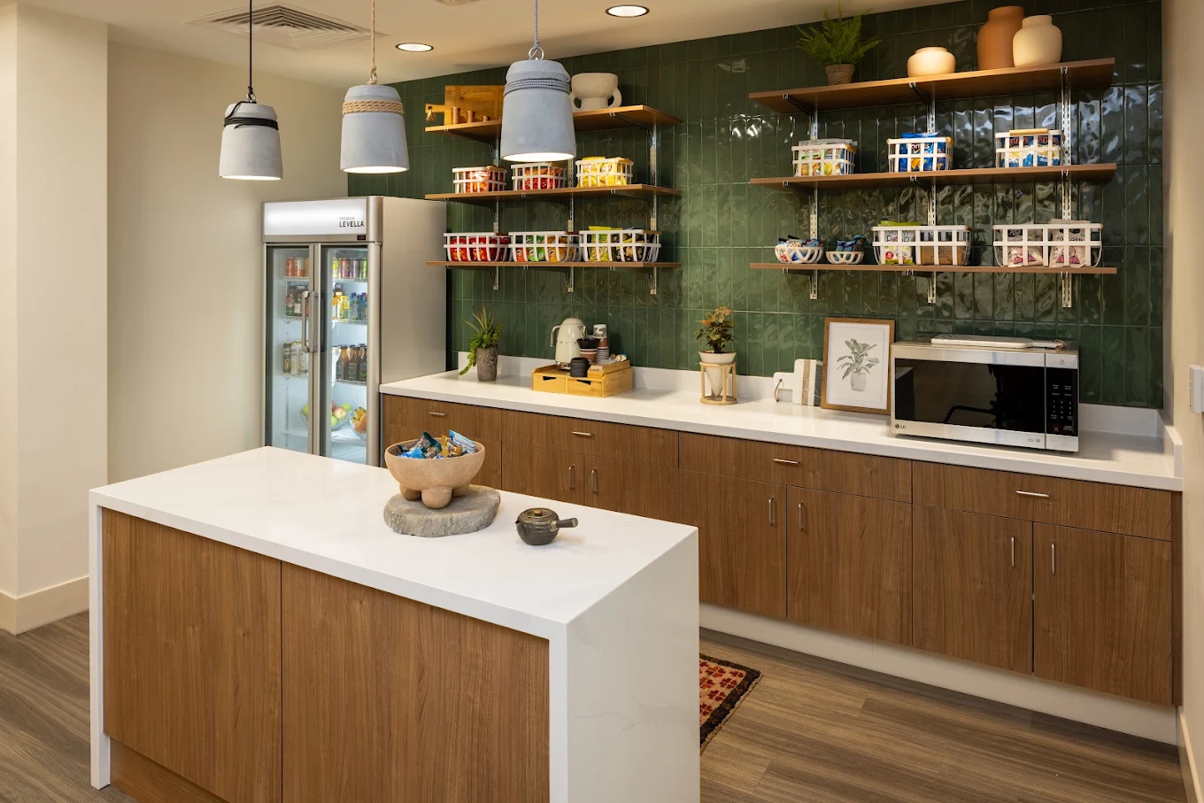 Snack area with refrigerator, microwave, and stocked shelves