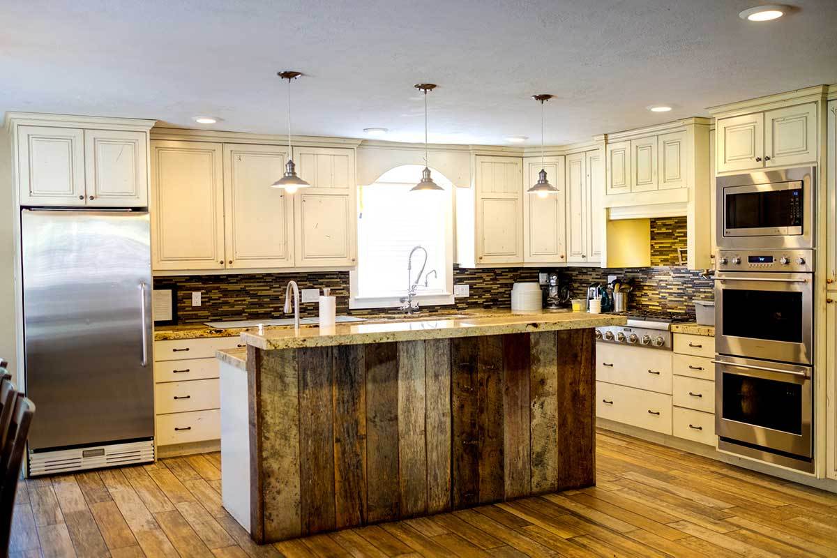 Large kitchen with island, double ovens, and pendant lights