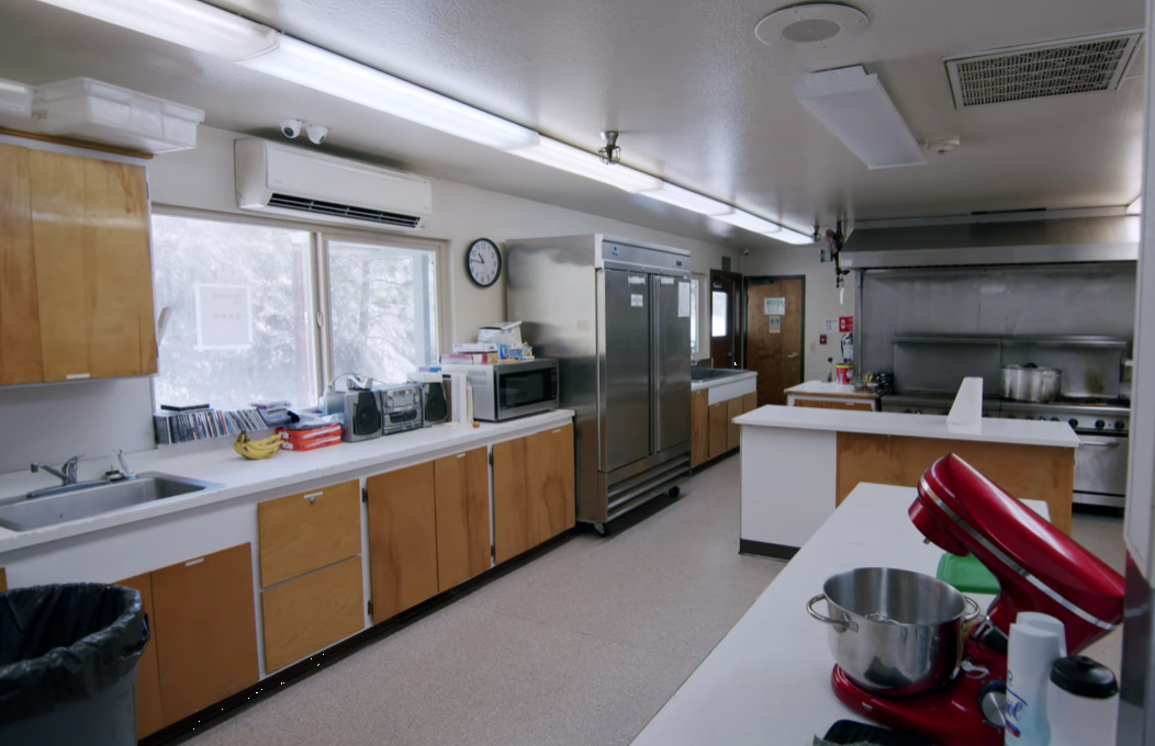 Large kitchen with stainless steel appliances and prep counters