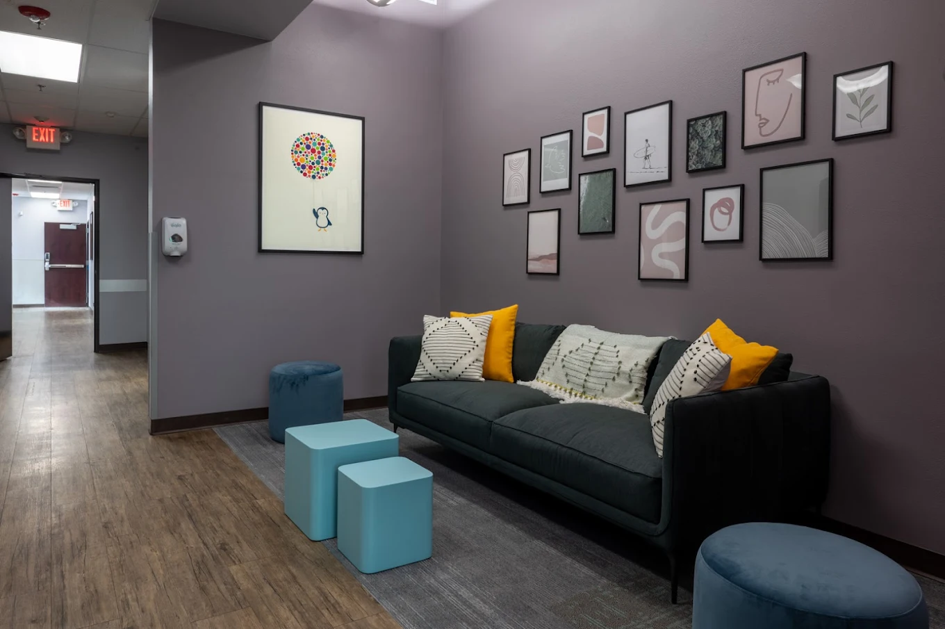 Comfortable patient lounge with sofa and modern artwork