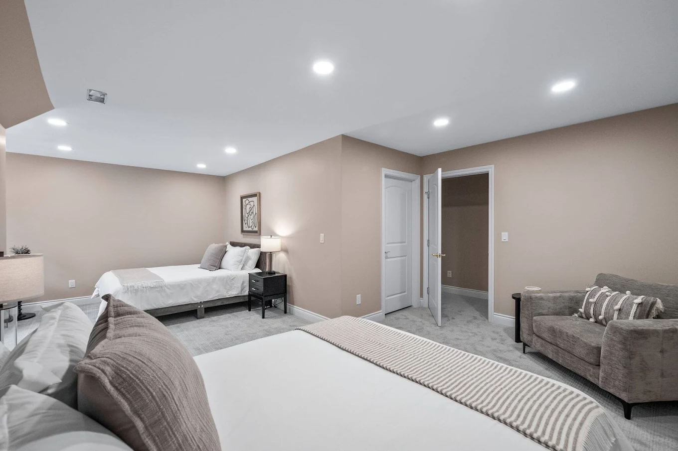 Double-bed room with carpet and soft lighting