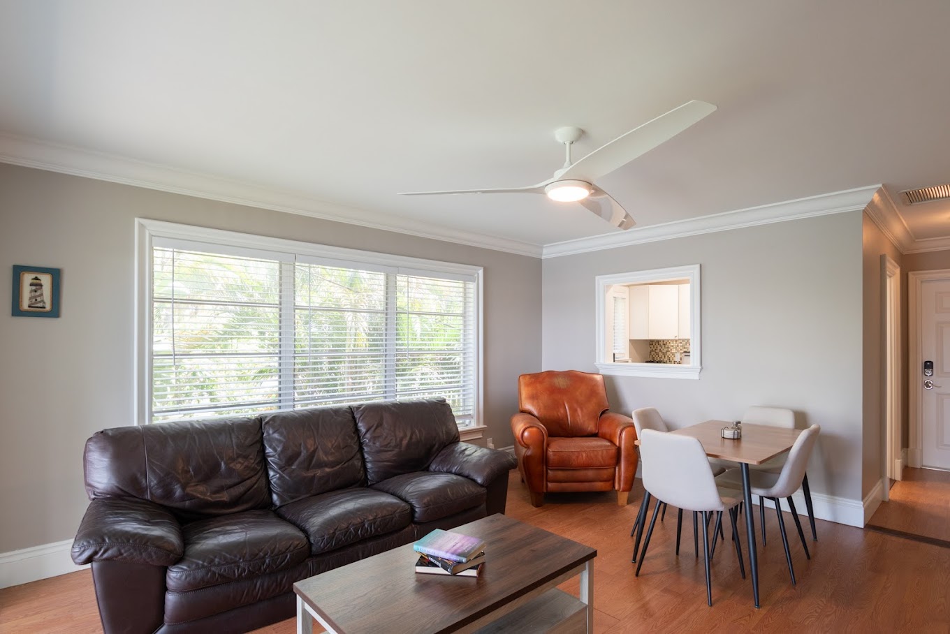 Living room with couch, table, and large window