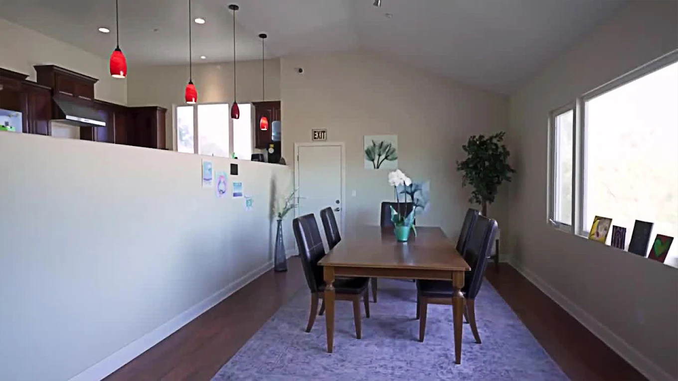 Modern dining area with wooden table and leather chairs