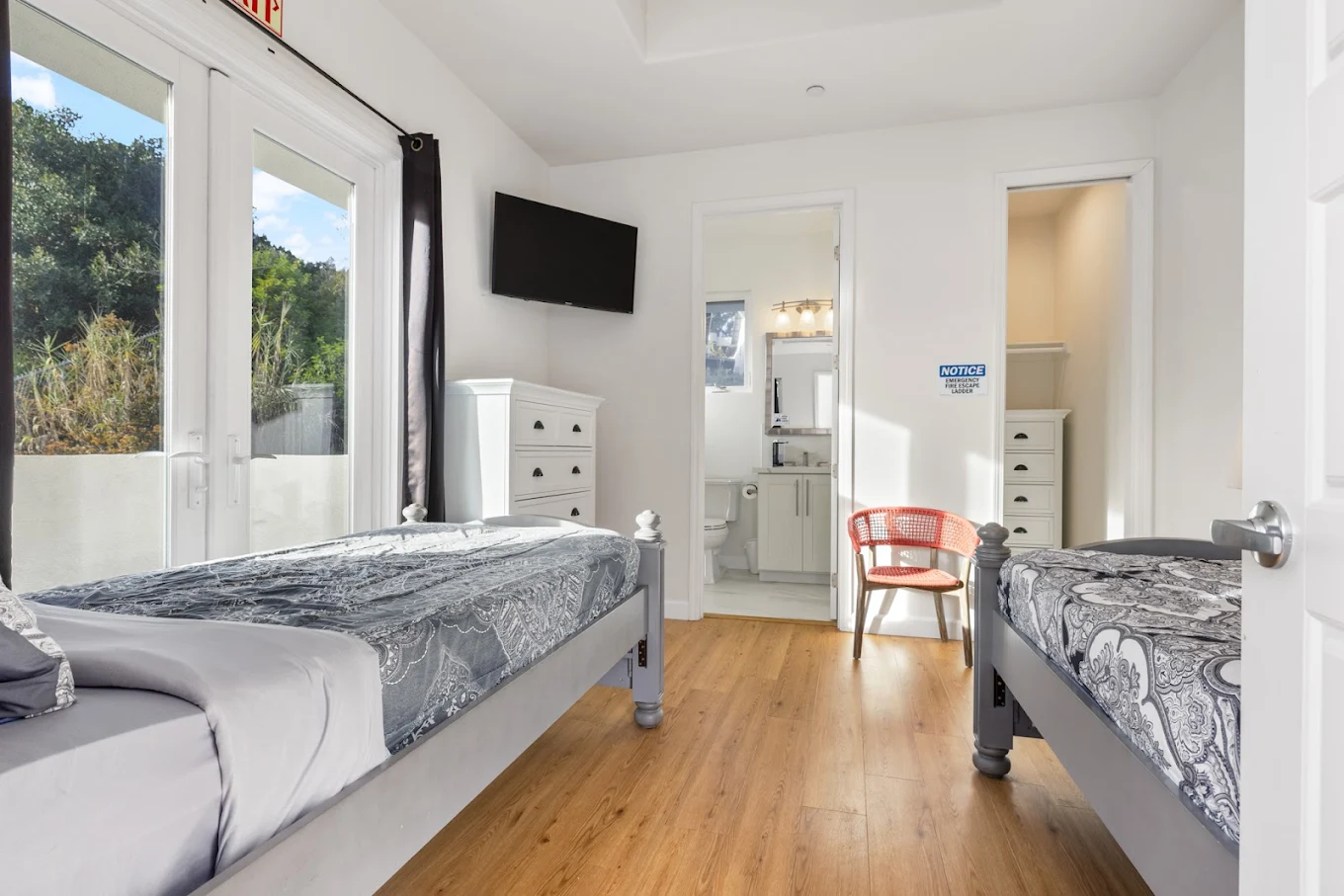 Bedroom with two twin beds, TV, and private bathroom