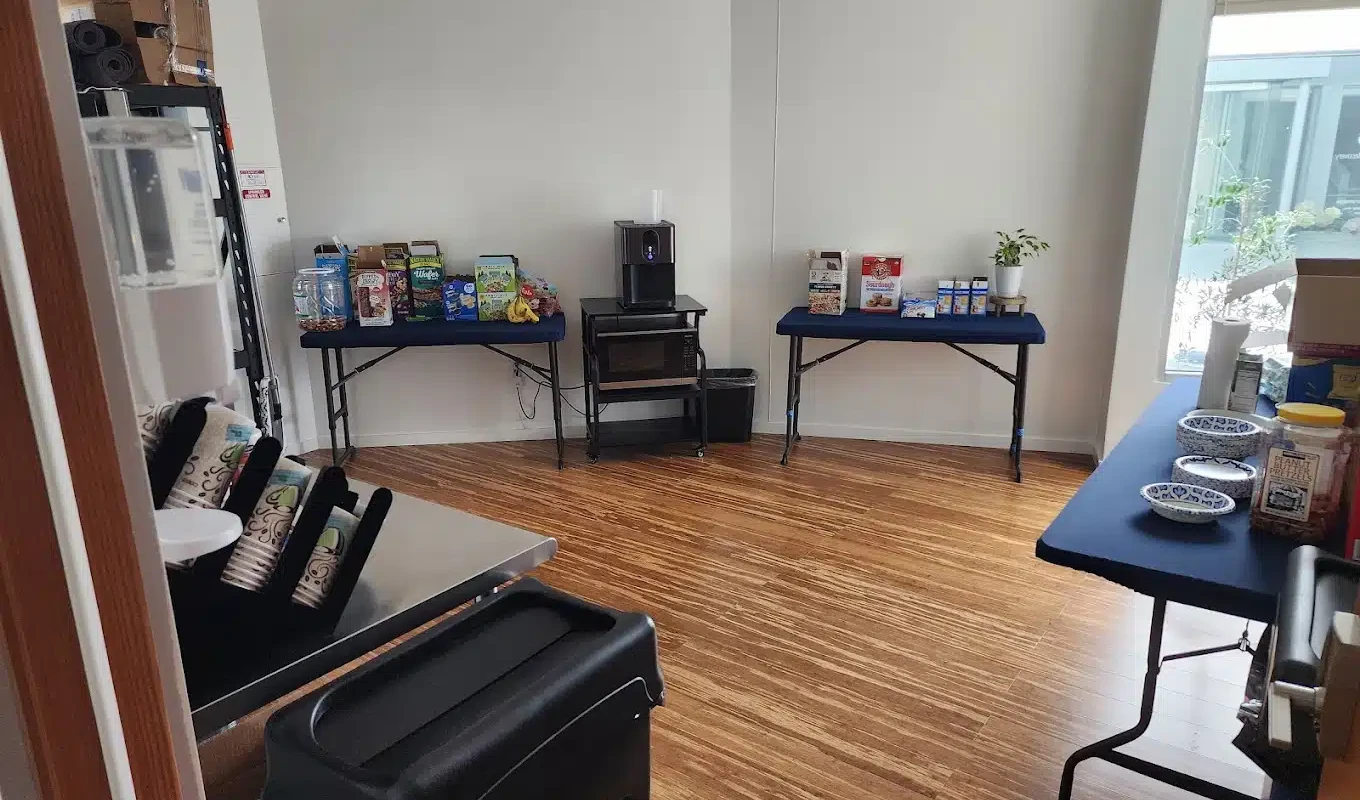 Tables with cereals, snacks, and coffee machine