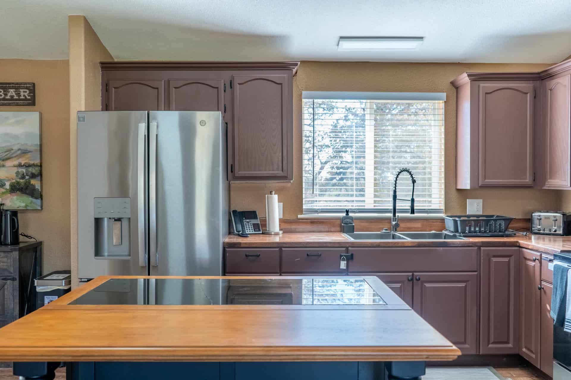Shared kitchen with island, sink, and stainless appliances