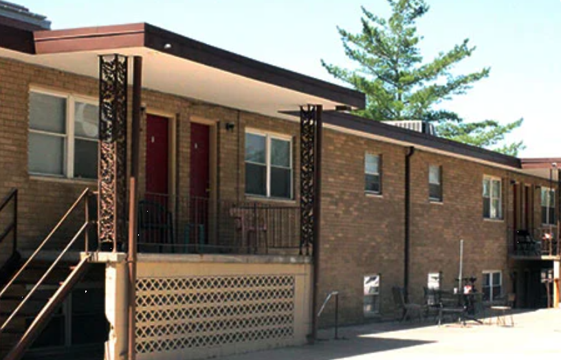 wo-story brick rehab facility with outdoor seating area