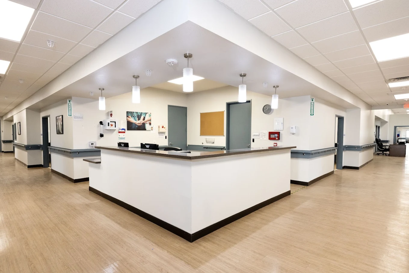 Modern reception area with central desk and hallway