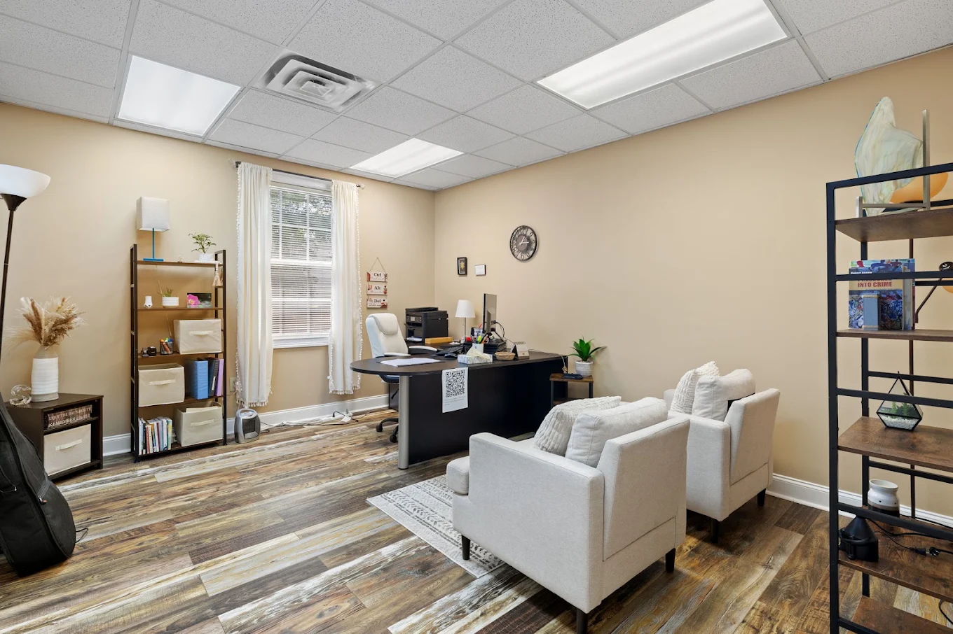 Counseling office with desk and comfortable client seating