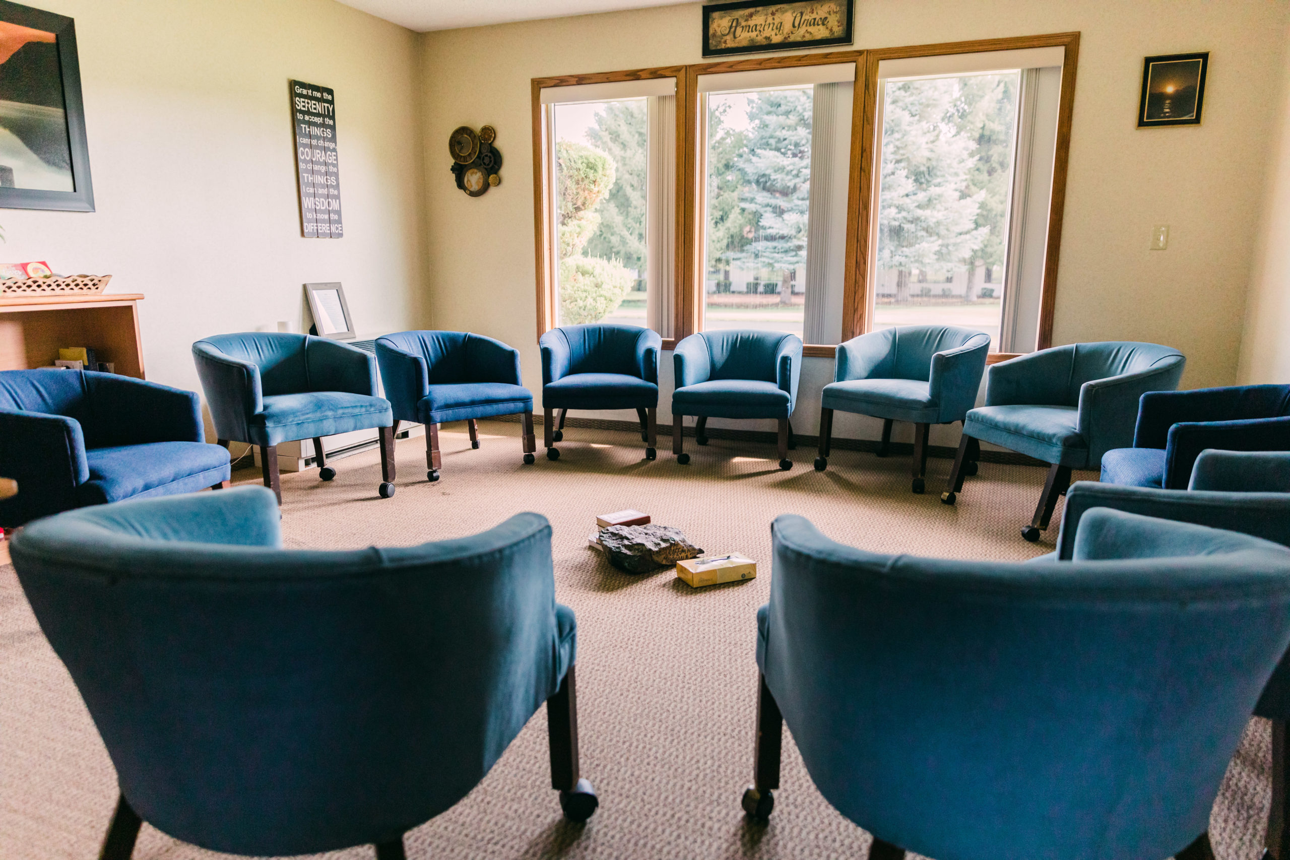 Circle of blue chairs in therapy session room