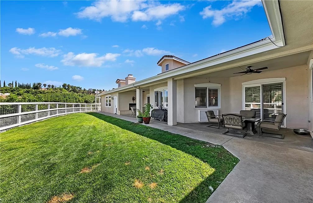 Backyard with a covered patio and seating.