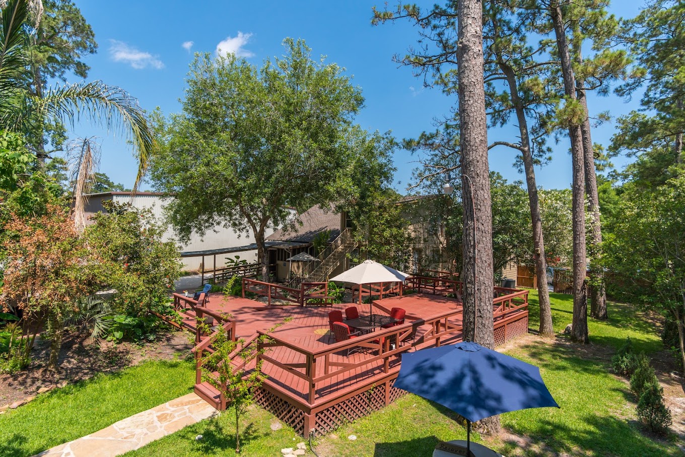 Outdoor deck by trees with seating.