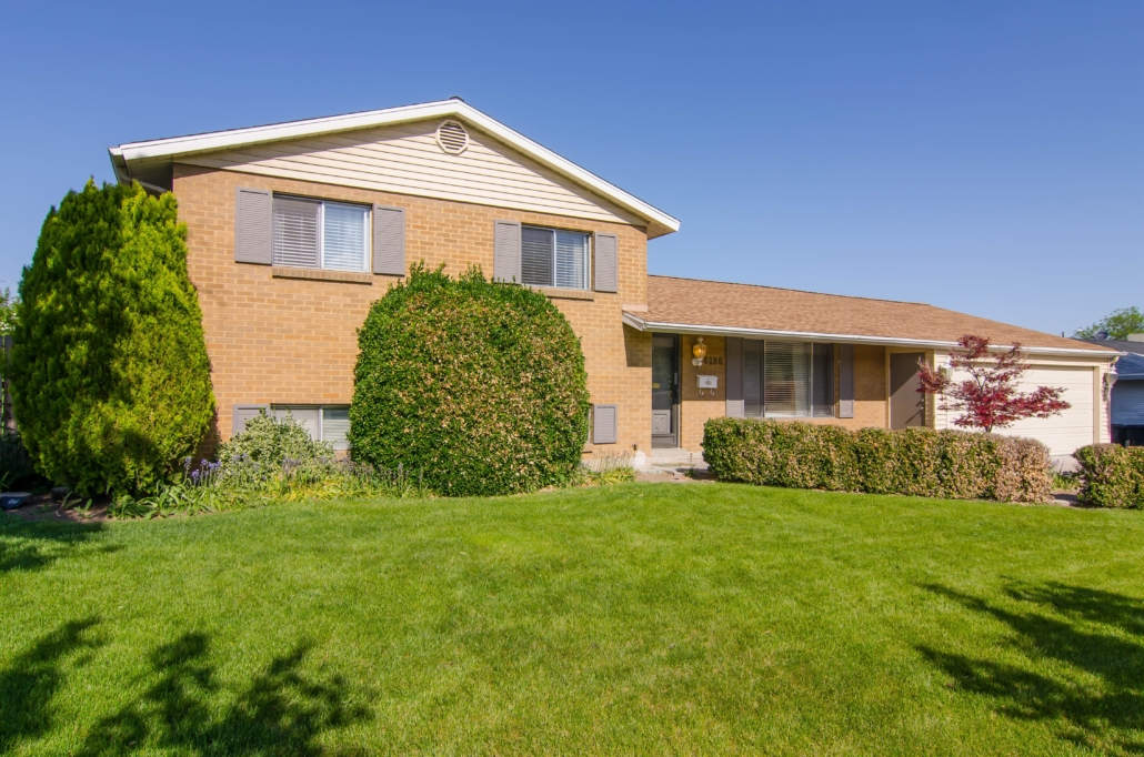 Two-story brick house with manicured lawn
