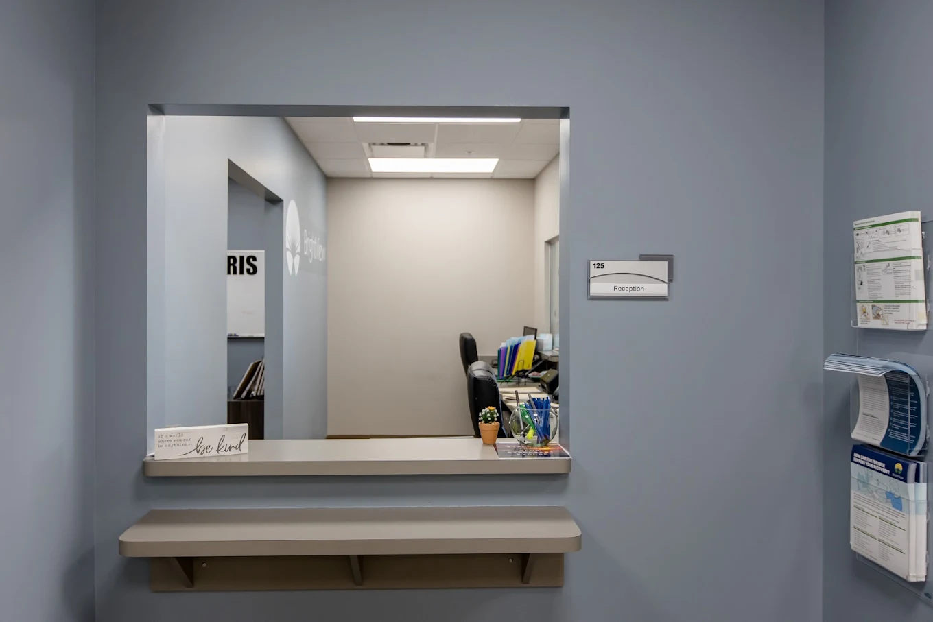 Reception service window with counter and informational materials