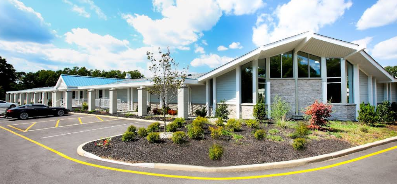 Modern single-story rehab facility with landscaped entry