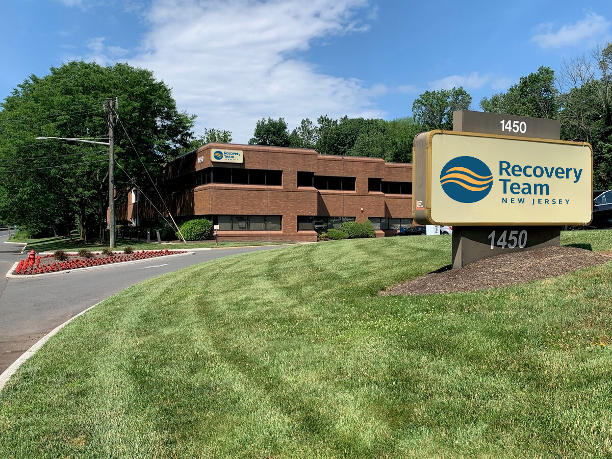 Brick treatment center building with sign for The Recovery Team.