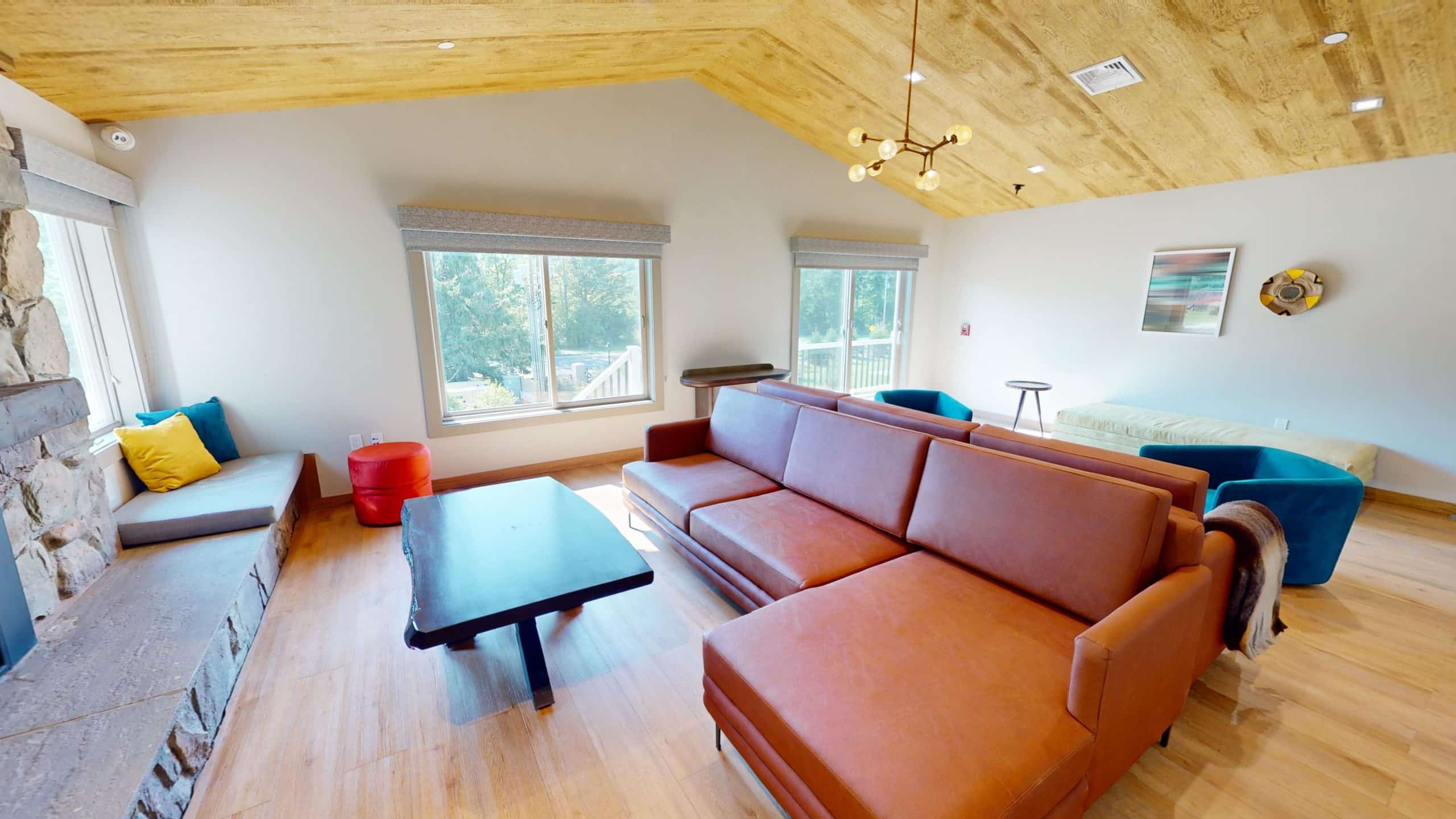 Living area with sofa, natural light, and warm decor