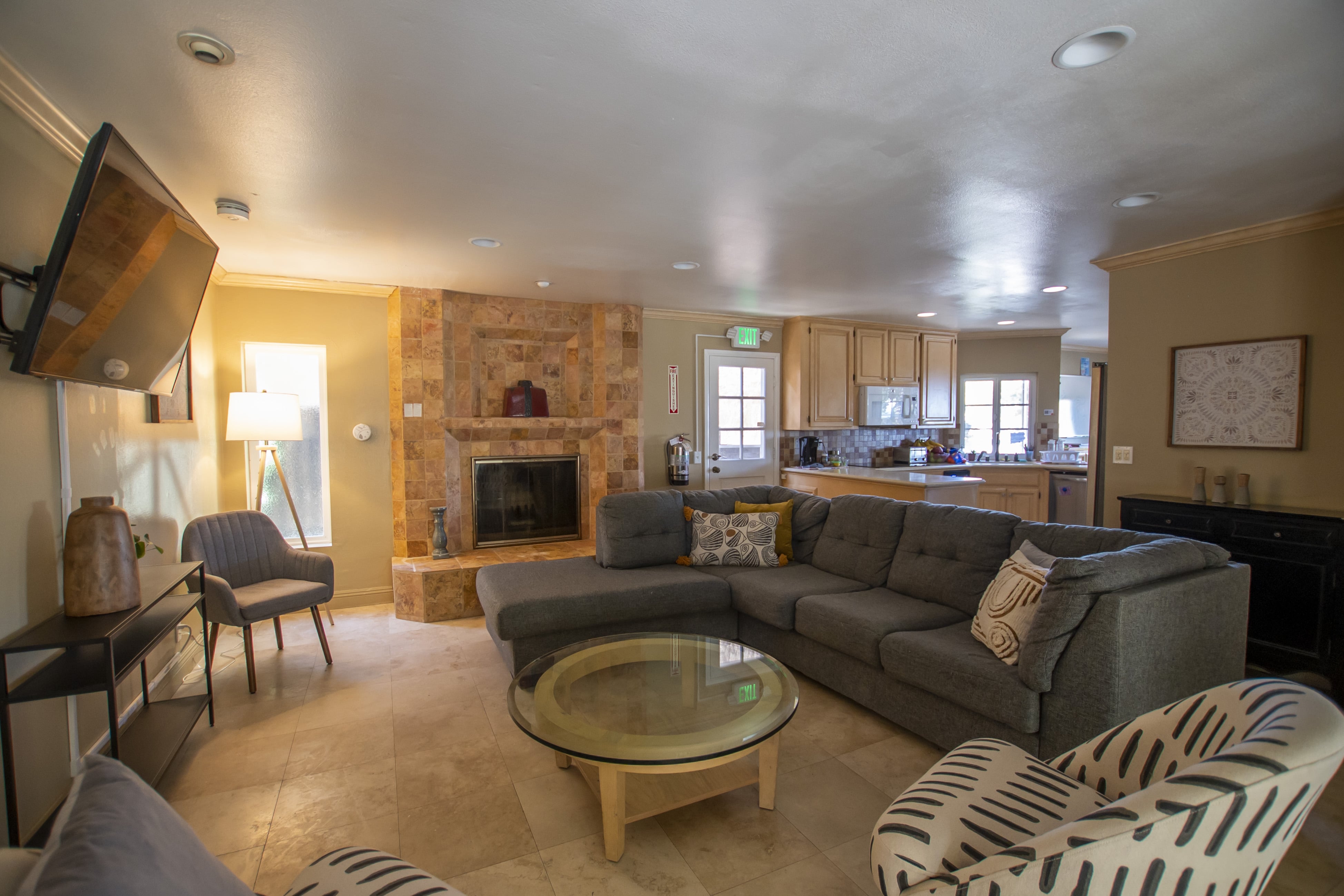 Spacious lounge with couch, chairs, and fireplace