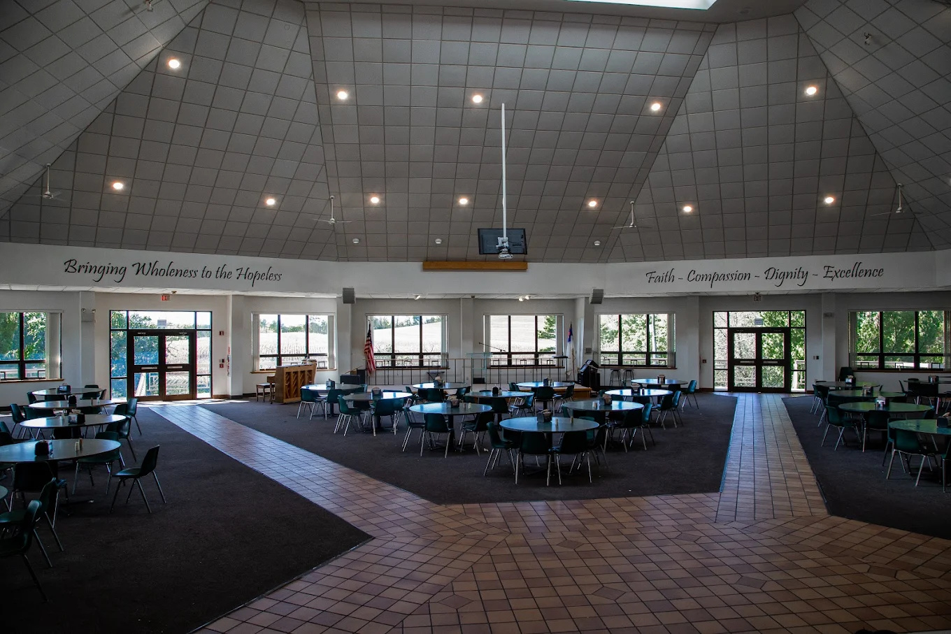 Large dining area with round tables and high ceiling