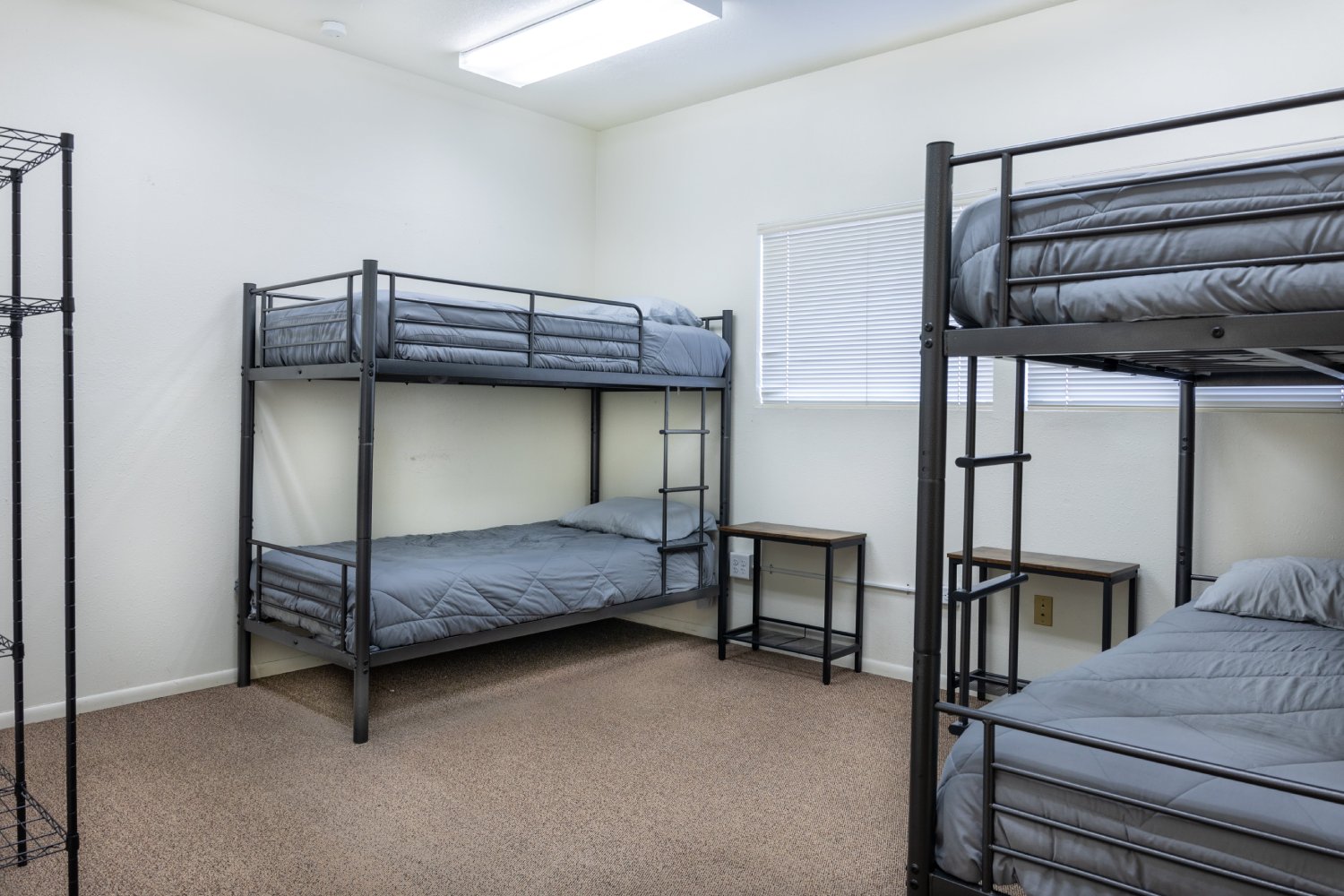 Dorm-style room with bunk beds and gray bedding