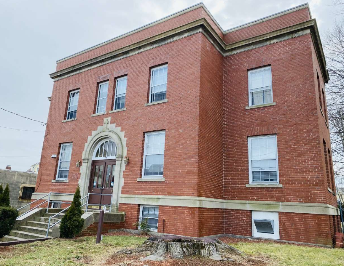 Brick exterior of Harmony House with front entrance and steps