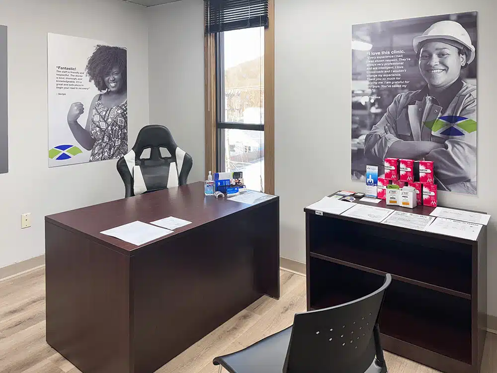 Office with desk, chair, and posters on wall
