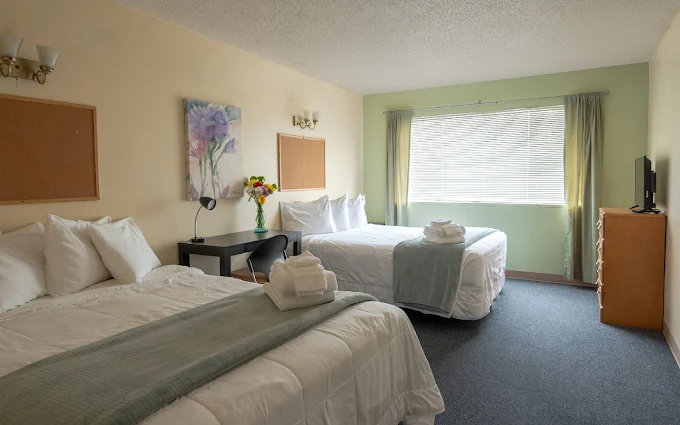Bedroom with two beds and folded towels