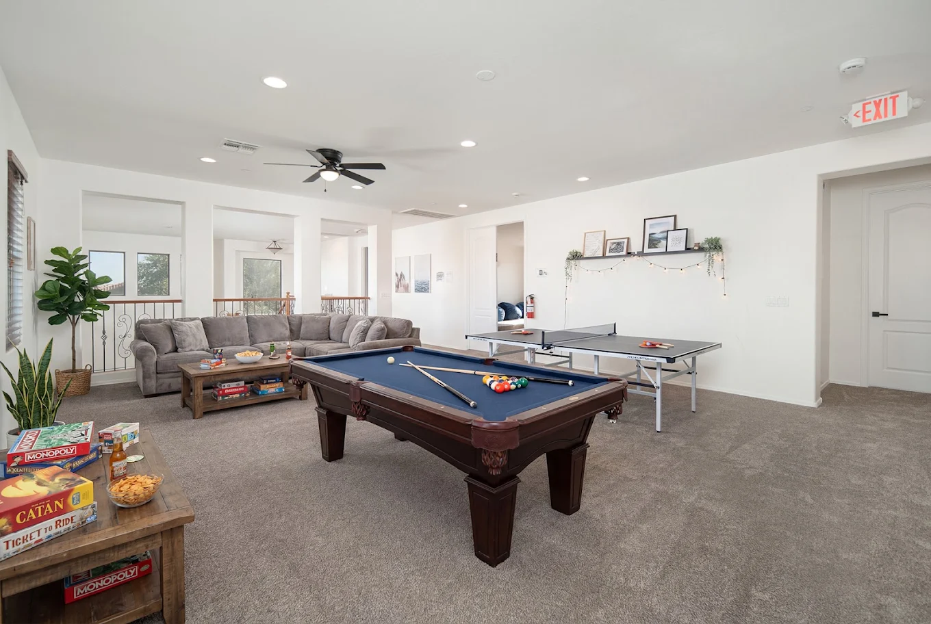 Recreation room with pool table, ping-pong table, board games, and sectional sofa