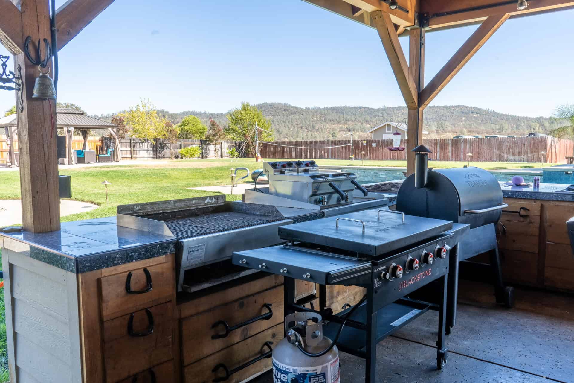 Outdoor grill and cooking station under covered patio