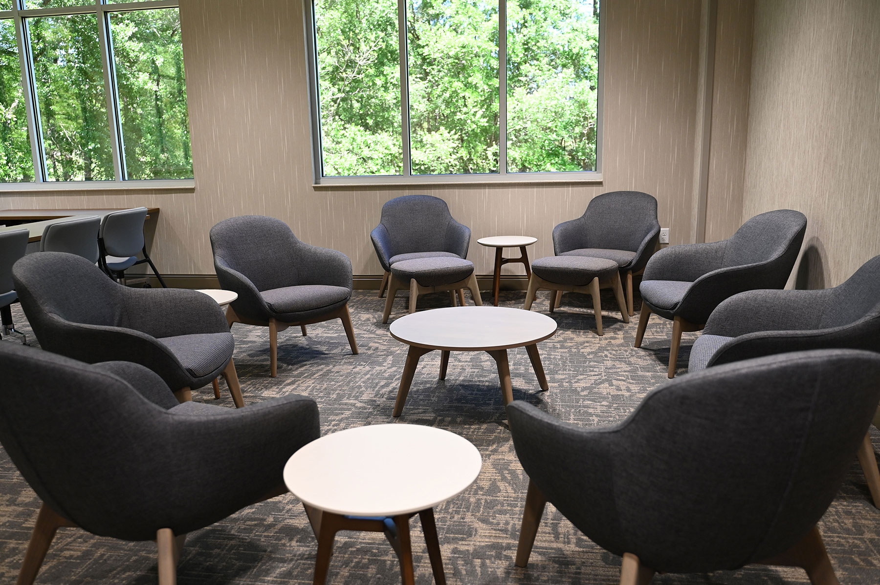 Group room with armchairs arranged around small tables