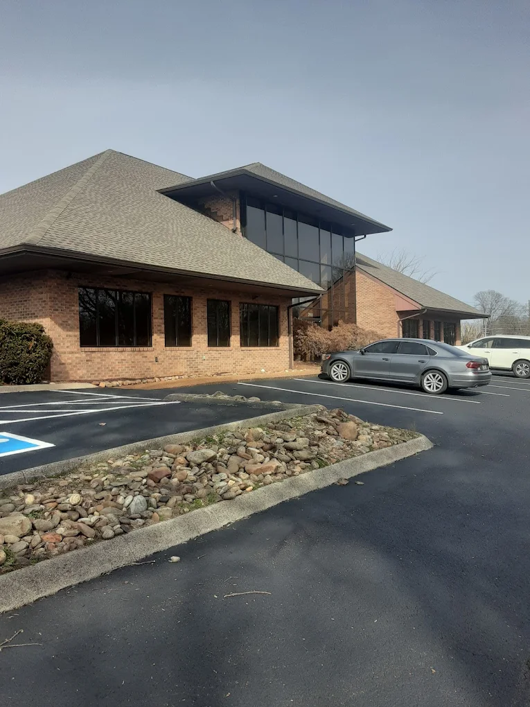 Brick rehab facility with parking lot and large windows