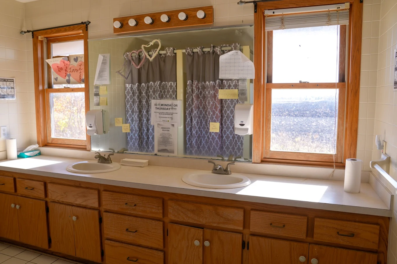 Double sink vanity with large mirror and natural light