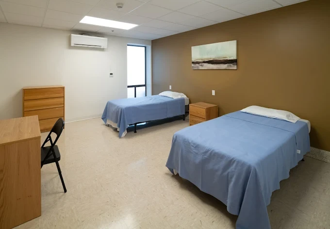 Two twin beds in rehab bedroom with simple furnishings