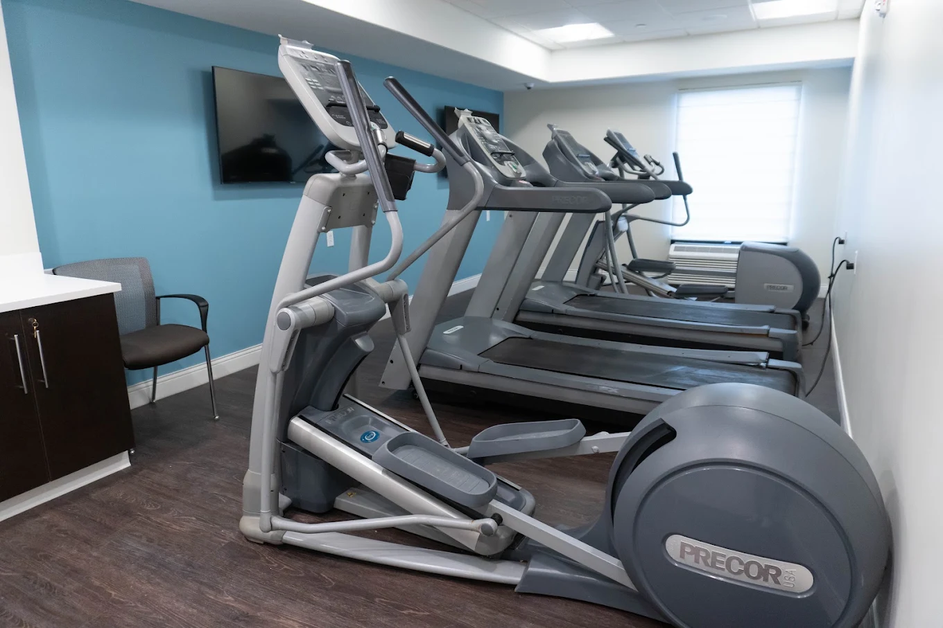 Fitness room with treadmills, elliptical, and exercise equipment