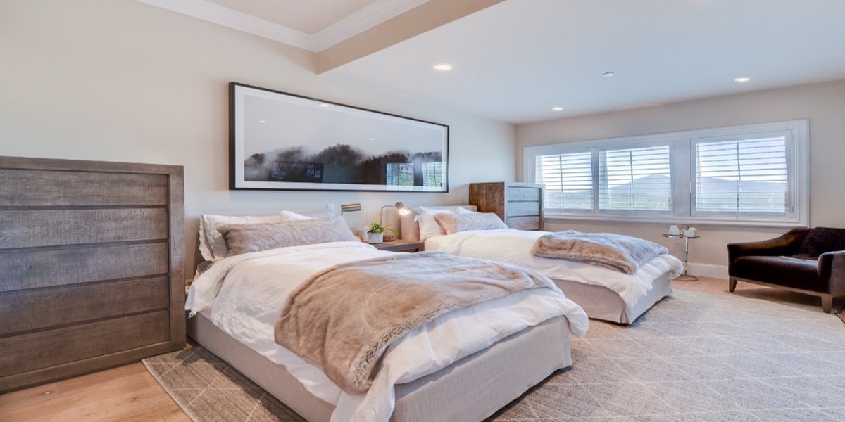 Spacious bedroom with twin beds and natural light.