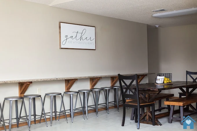 Shared dining area with table, benches, and bar seating