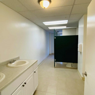Bathroom with sinks, mirrors, and shower stalls