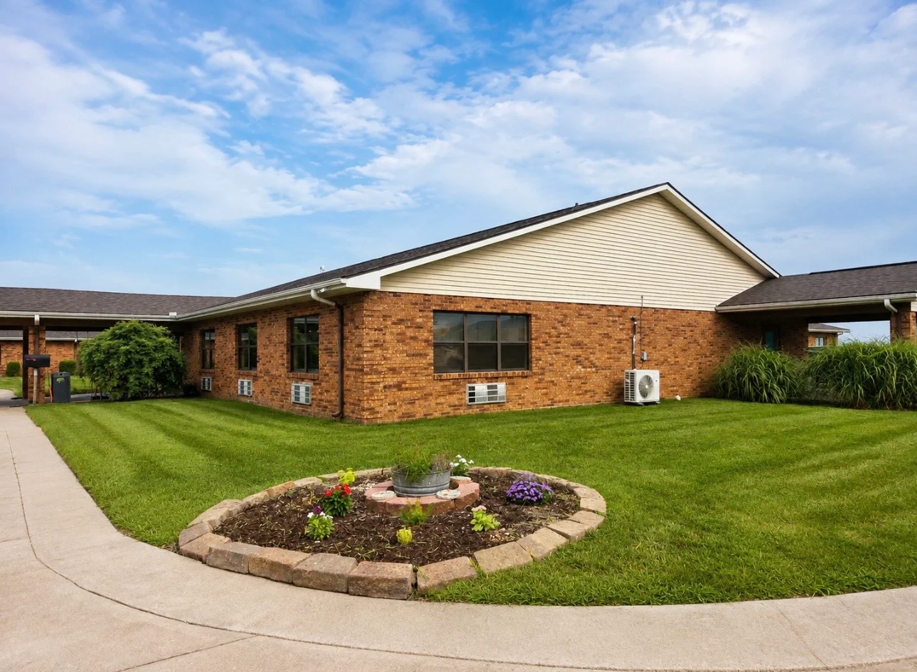 Brick treatment center with landscaped lawn and walkway