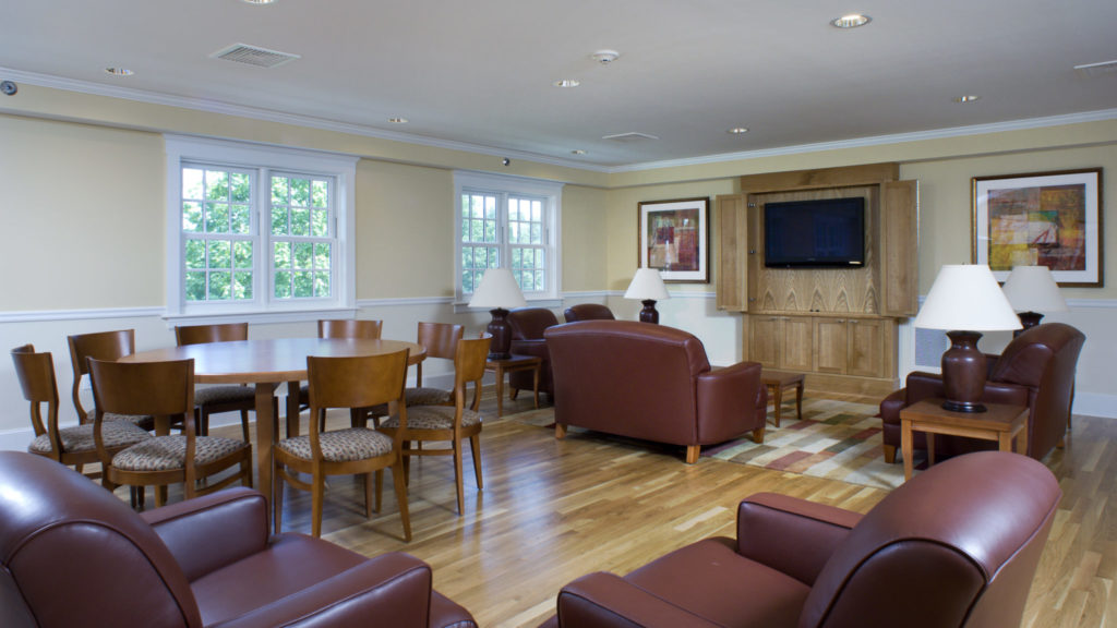 Spacious meeting area with sofas, tables, and natural light