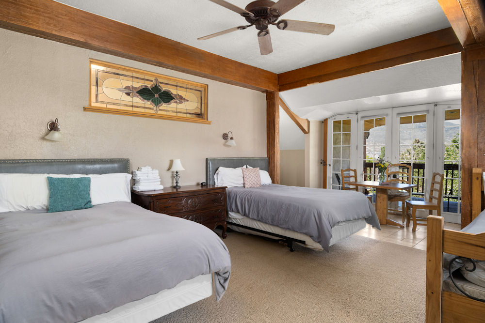 Shared bedroom with two beds and nightstands.