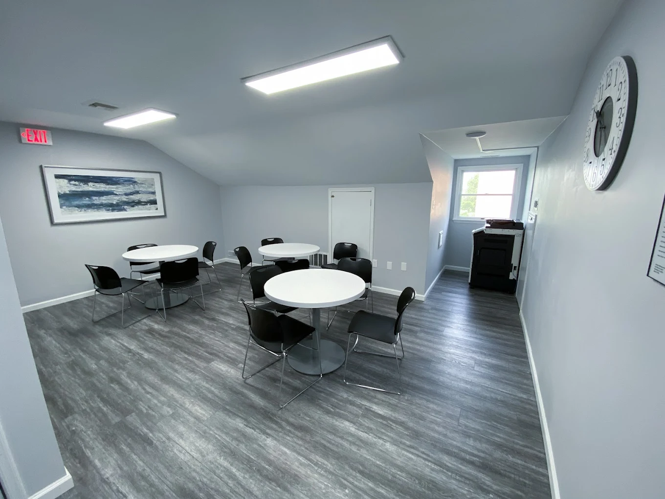 Seating area with Achieve logo, chairs, and décor