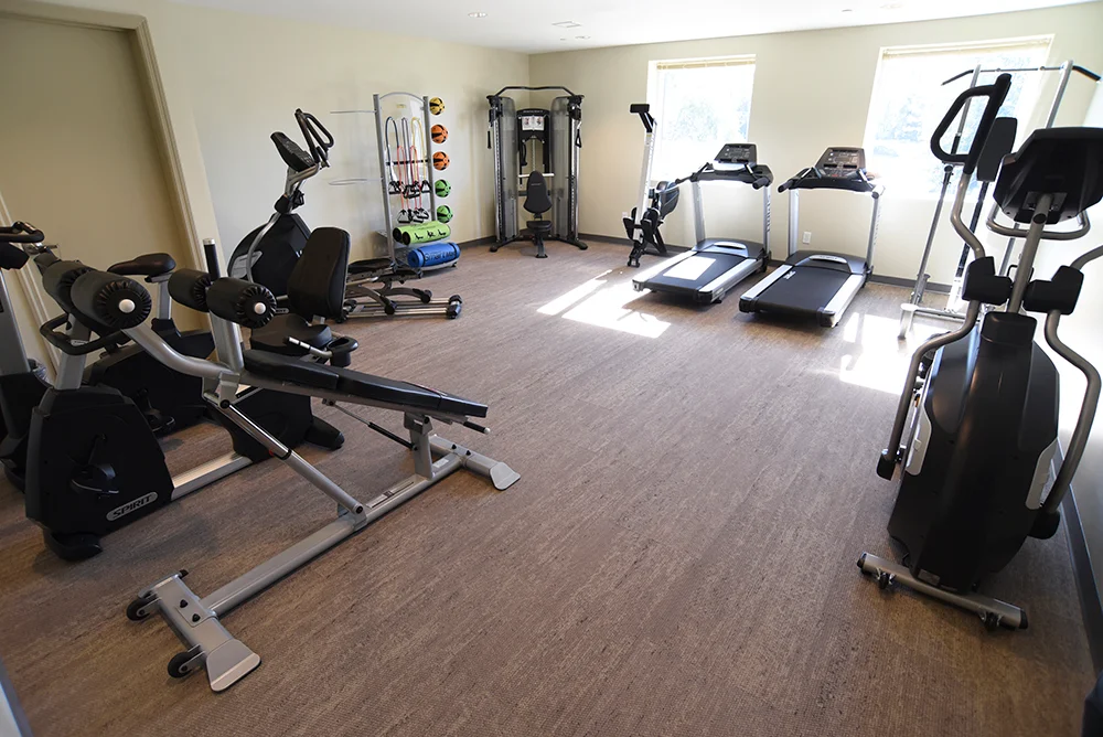 Fitness room with treadmills, exercise bikes, and gym equipment