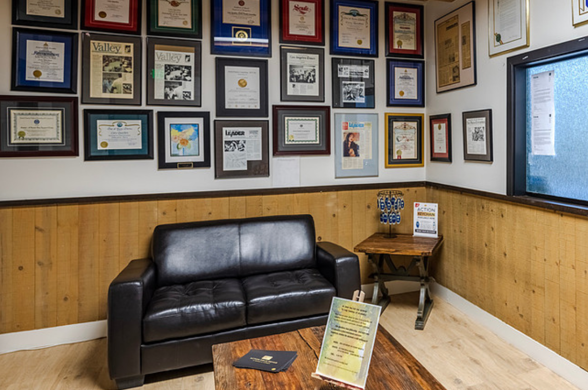 Lobby with leather couch and wall of awards.