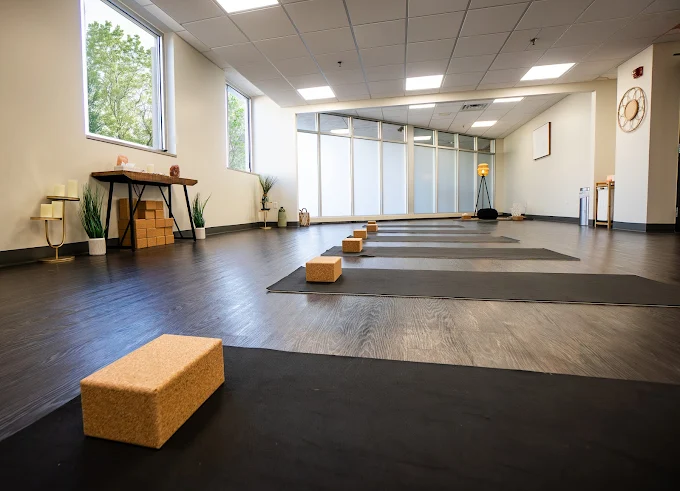 Yoga room with mats and blocks near large windows