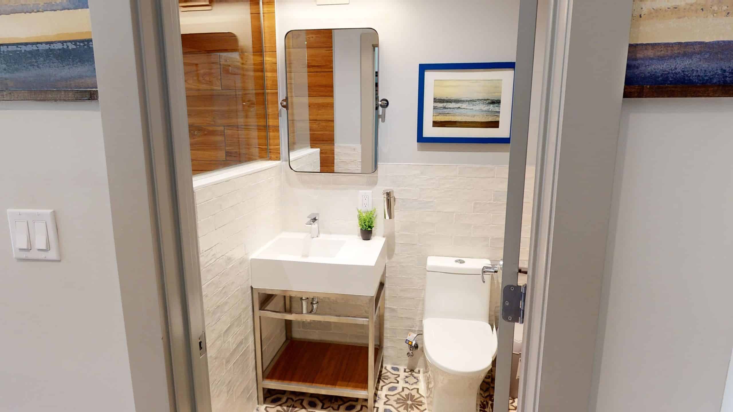 Modern bathroom with sink, mirror, and shower at Britelife
