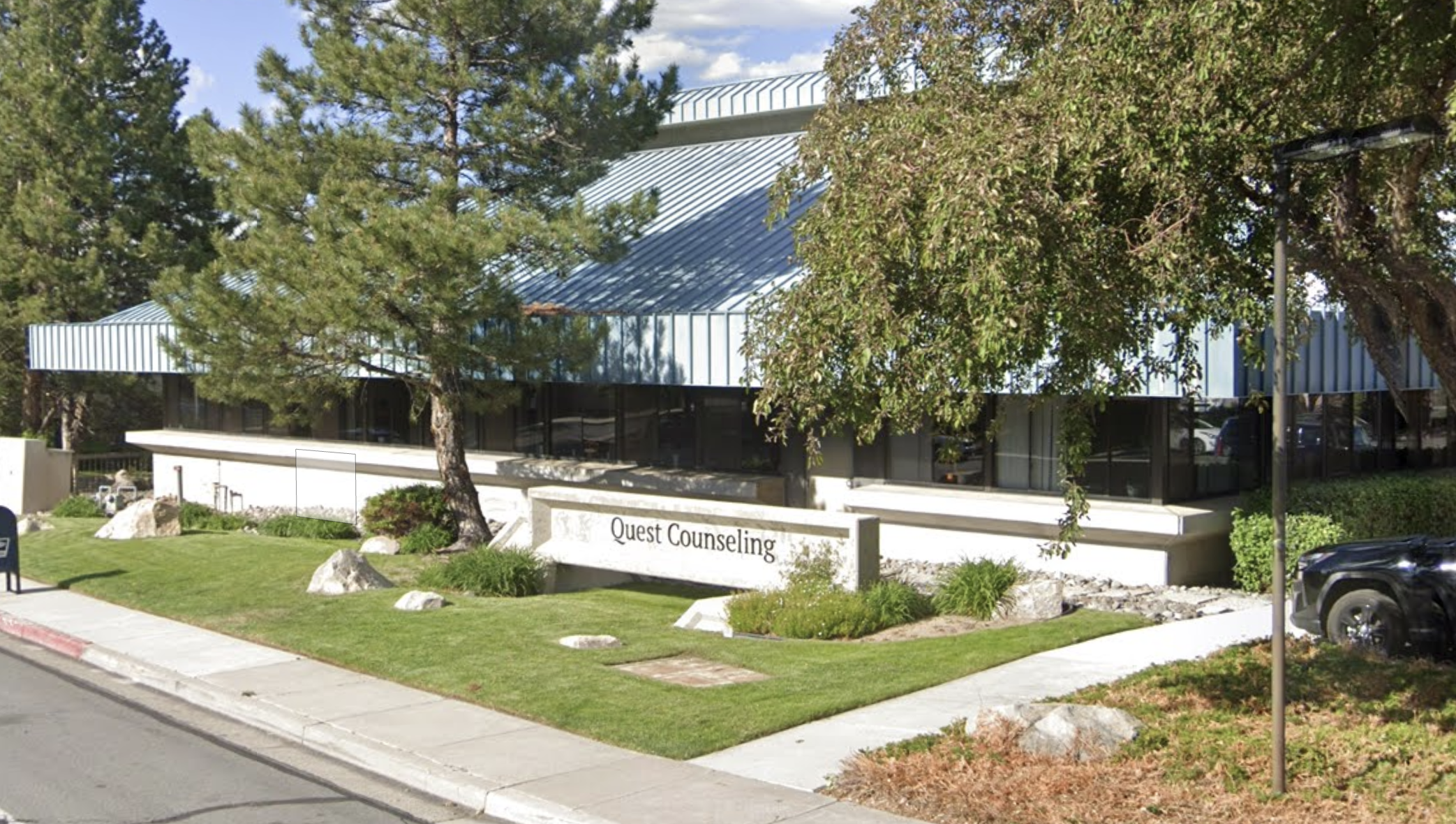 Quest Counseling building exterior surrounded by trees and lawn