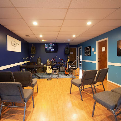 Small stage with chairs and guitars for music therapy