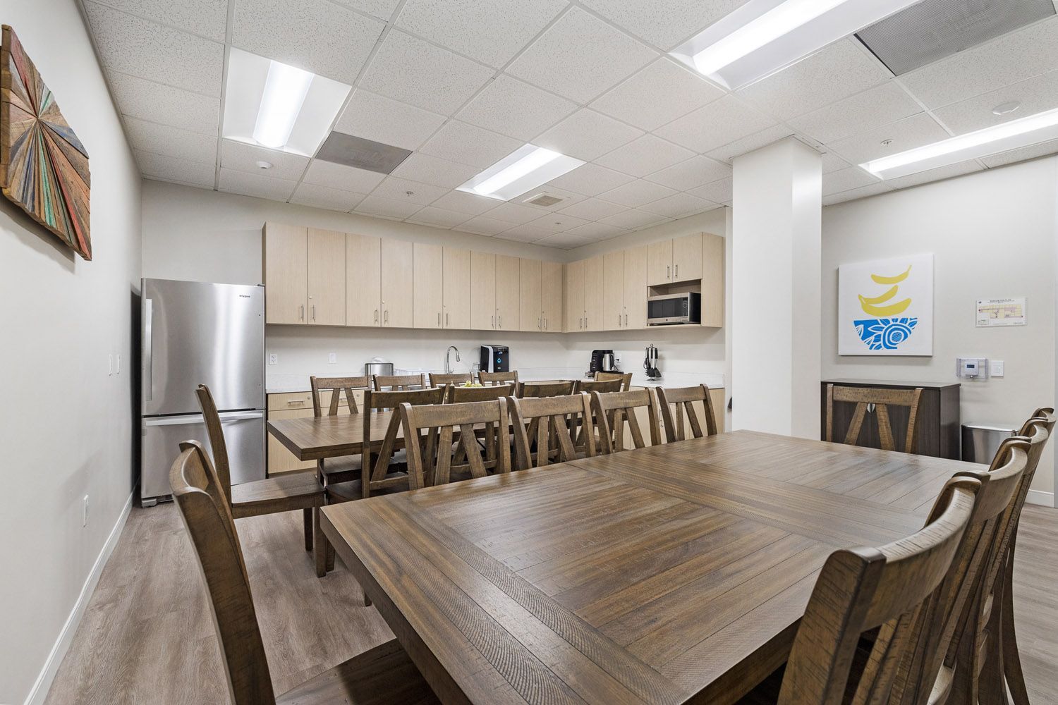 Dining room with wooden tables and kitchen cabinets