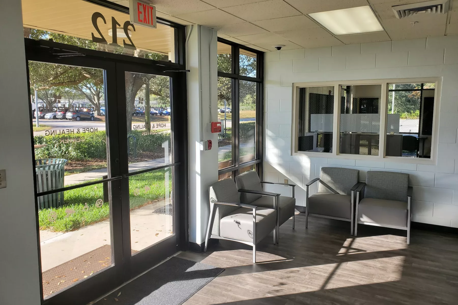 Bright entry lounge with chairs and large glass doors