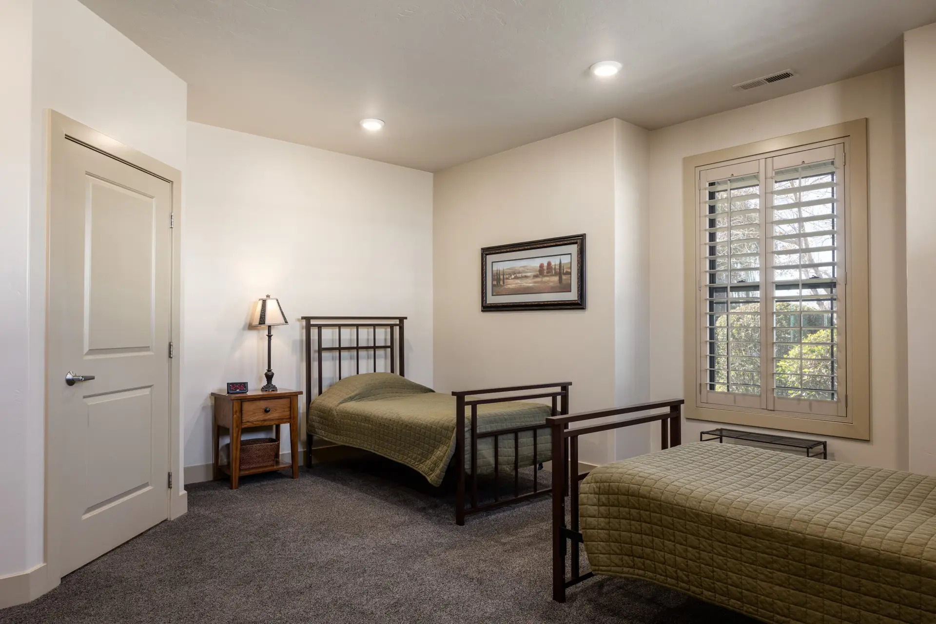 Room with two twin beds and framed wall art